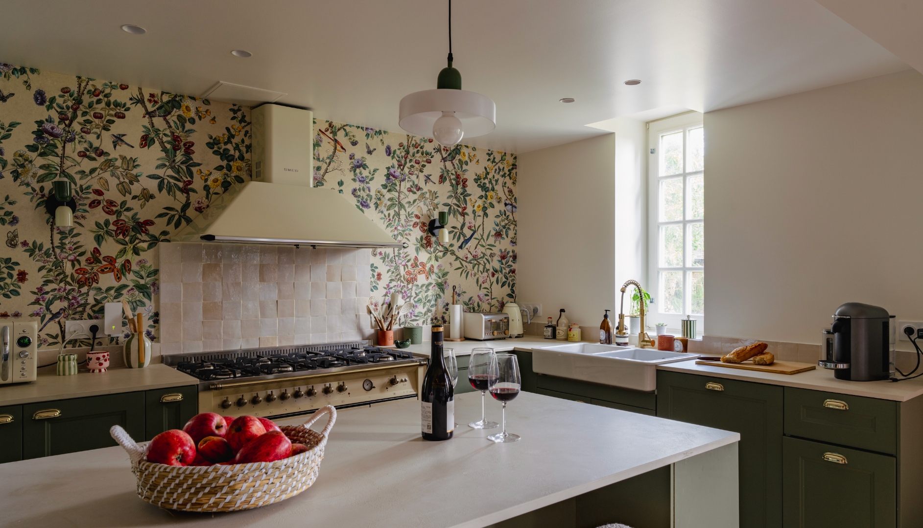 Manor kitchen with range cooker, floral wallpaper, and central island