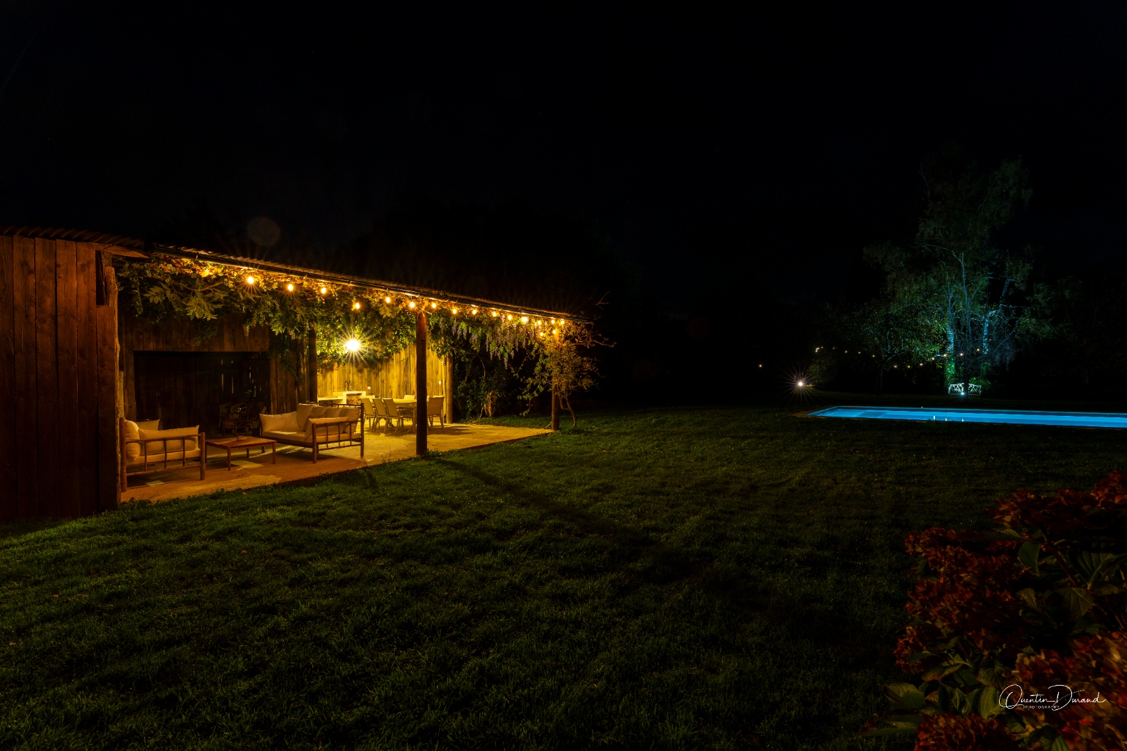 Night view of the pool and lit terrace